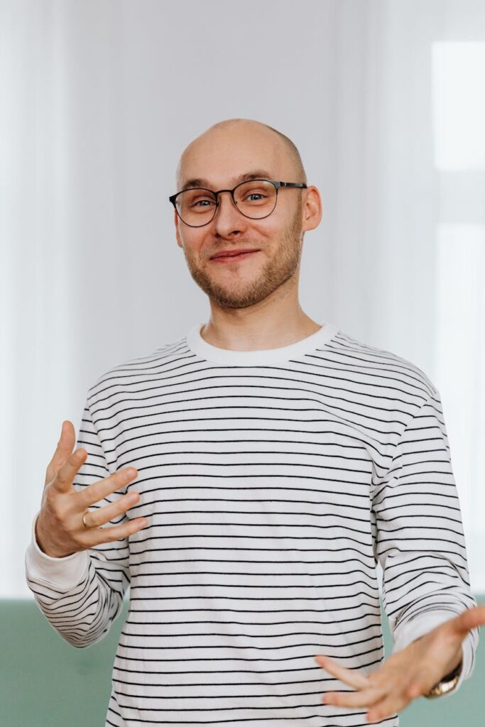 man in white and black striped shirt with black framed eyeglasses