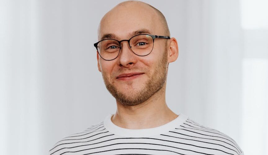 man in white and black striped shirt with black framed eyeglasses