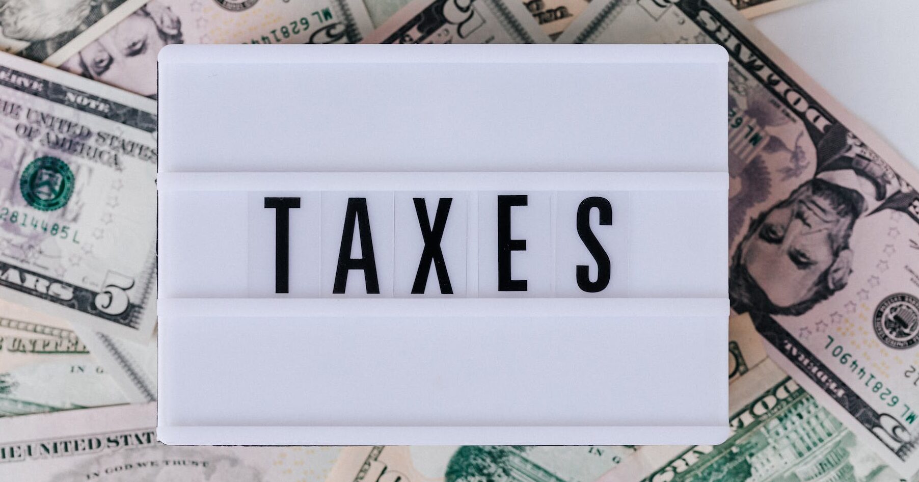 quote box ontop of stack of paper bills